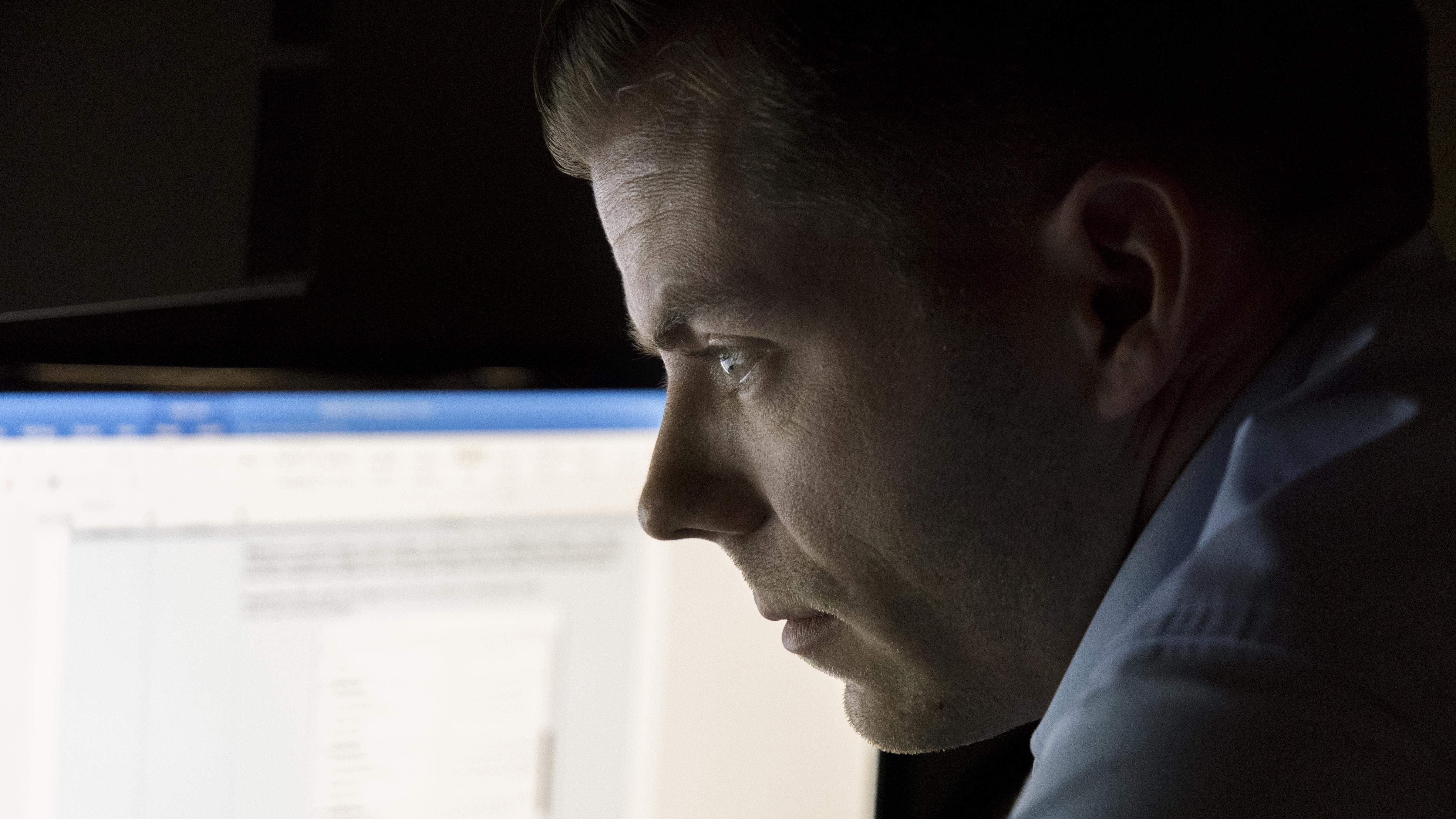 Army CID Special Agent studies a computer screen displaying evidence from a crime scene